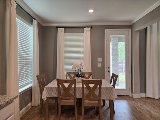 dining room with ornamental molding and dark wood-type flooring