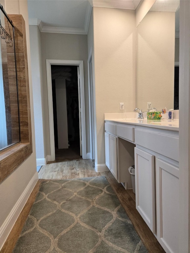 bathroom with hardwood / wood-style floors, a shower, crown molding, and vanity