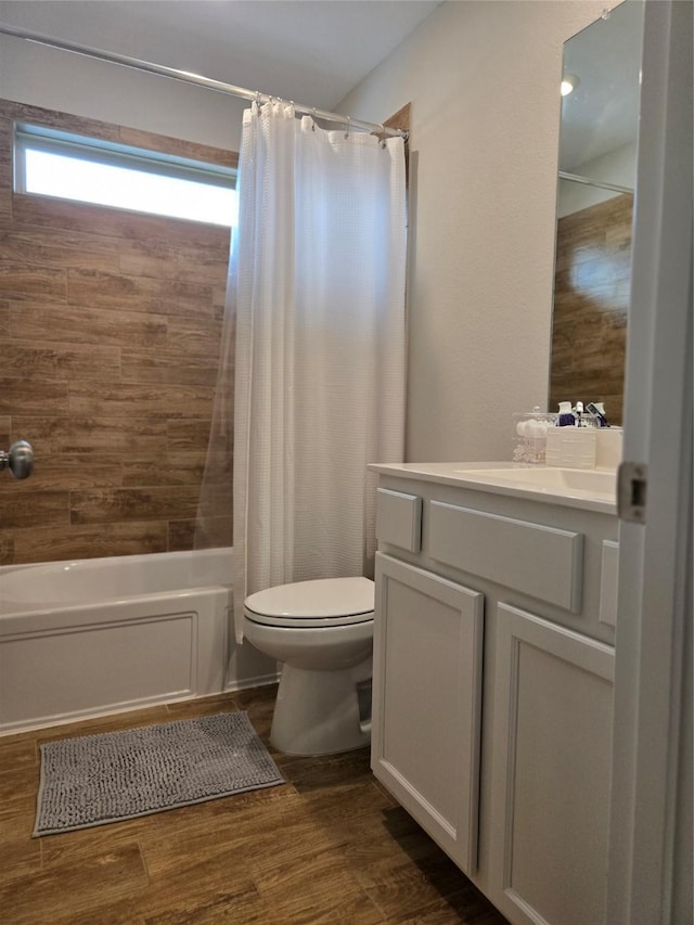 full bathroom with toilet, shower / tub combo, vanity, and wood-type flooring