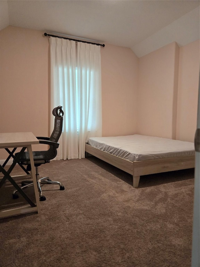 bedroom with vaulted ceiling and carpet