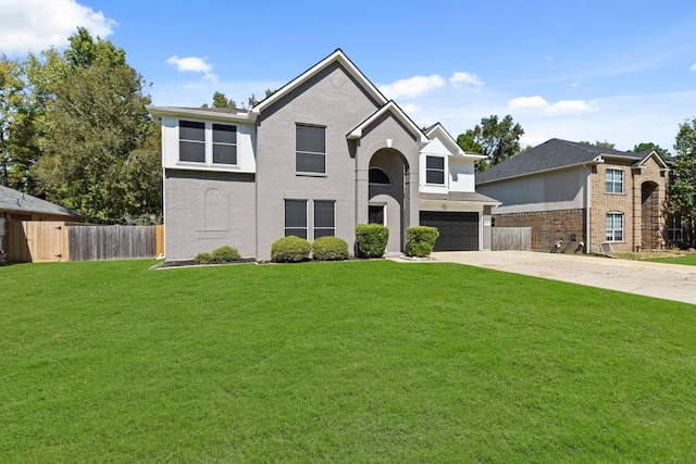 view of front of property featuring a front yard and a garage