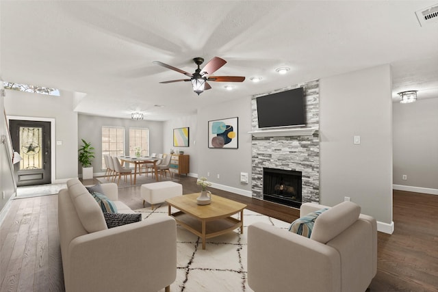 living room featuring a fireplace, ceiling fan, and hardwood / wood-style flooring