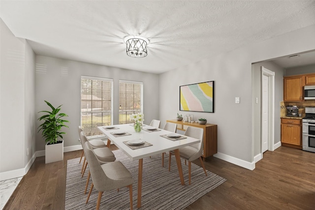 dining area featuring dark hardwood / wood-style flooring, an inviting chandelier, and a textured ceiling