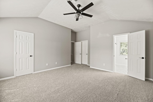 unfurnished bedroom featuring vaulted ceiling, ceiling fan, carpet flooring, and connected bathroom