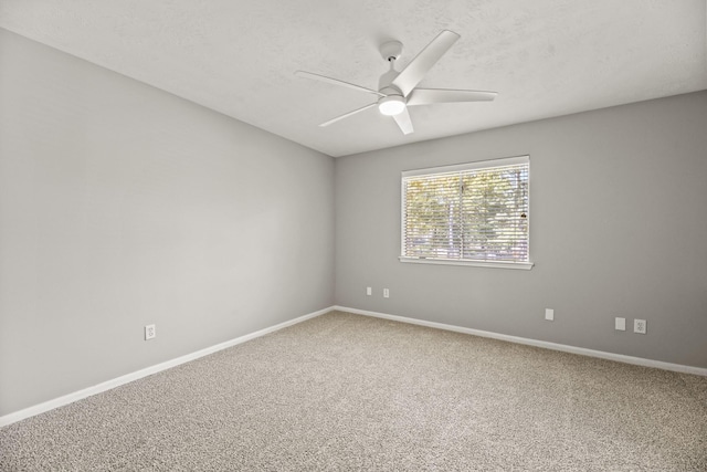 empty room featuring a textured ceiling, ceiling fan, and carpet flooring