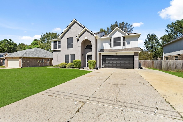 view of property featuring a front yard and a garage