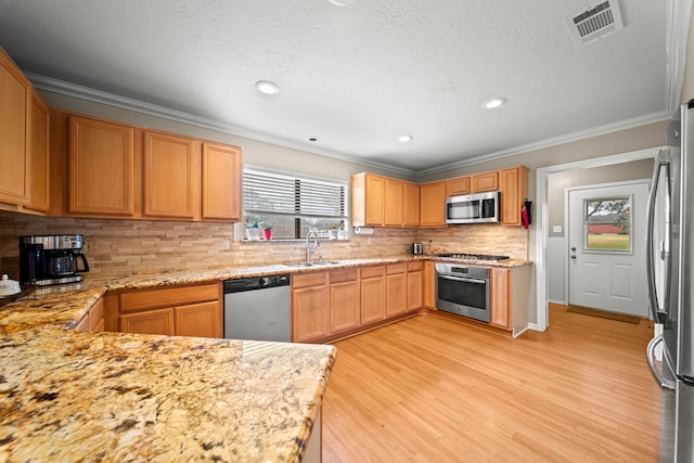 kitchen featuring stainless steel appliances, sink, tasteful backsplash, and crown molding