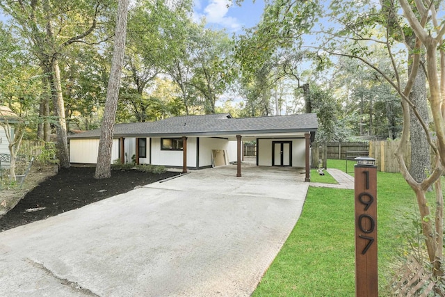 ranch-style house with a front yard and a carport