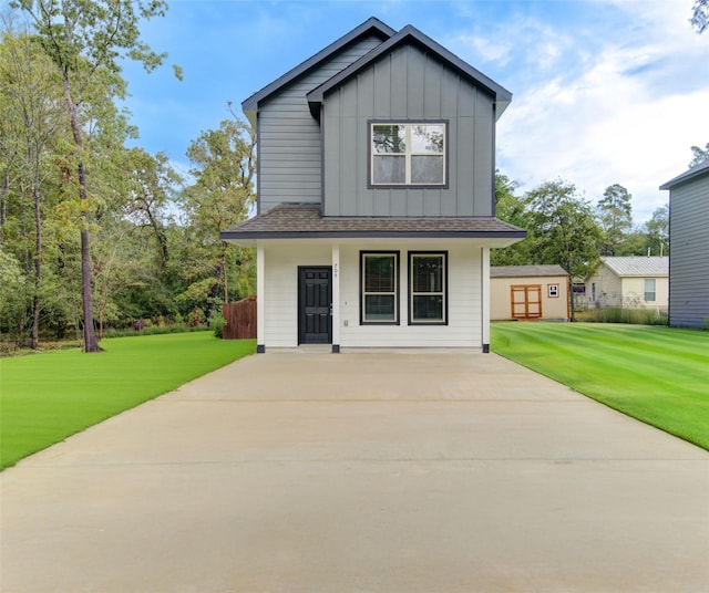 view of front facade with a front lawn and a storage shed