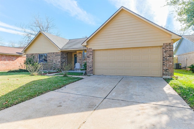 ranch-style home with cooling unit, a front yard, and a garage