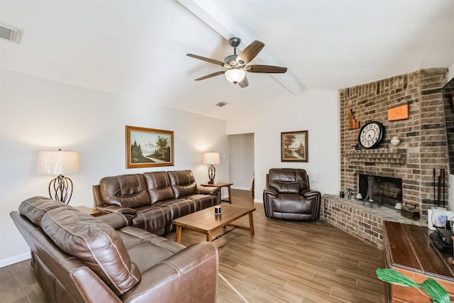 living room with lofted ceiling with beams, a fireplace, hardwood / wood-style floors, and ceiling fan