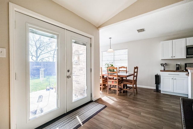 doorway with dark wood-type flooring, french doors, and lofted ceiling