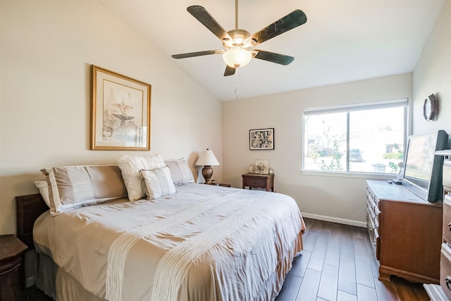 bedroom with vaulted ceiling, ceiling fan, and dark hardwood / wood-style flooring