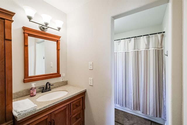 bathroom with a shower with shower curtain and vanity