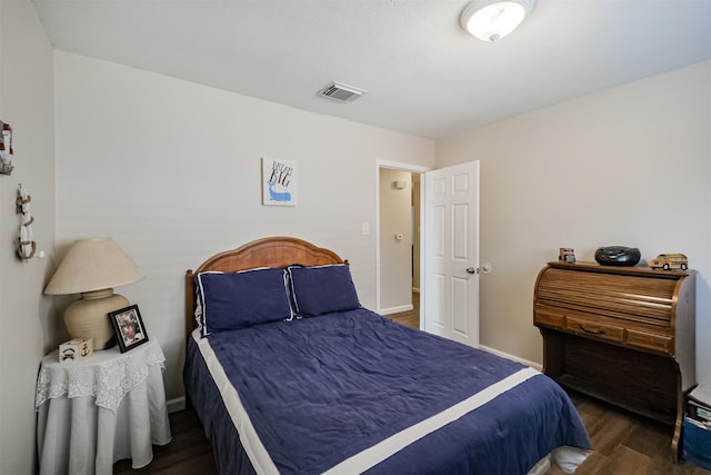 bedroom with dark wood-type flooring