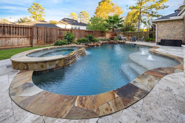 view of pool with a patio, pool water feature, and an in ground hot tub