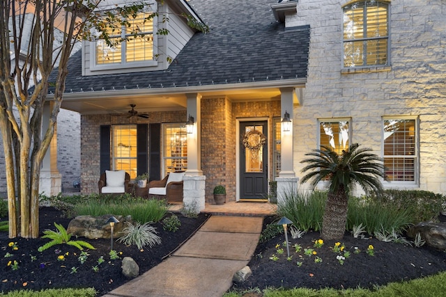 doorway to property with ceiling fan and a porch