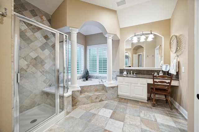 bathroom featuring ornate columns, independent shower and bath, and vanity