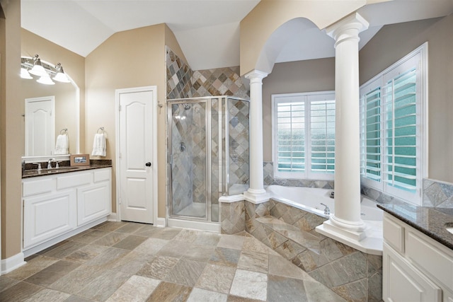 bathroom featuring shower with separate bathtub, vaulted ceiling, vanity, and ornate columns