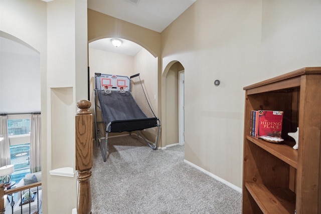 hallway with light colored carpet