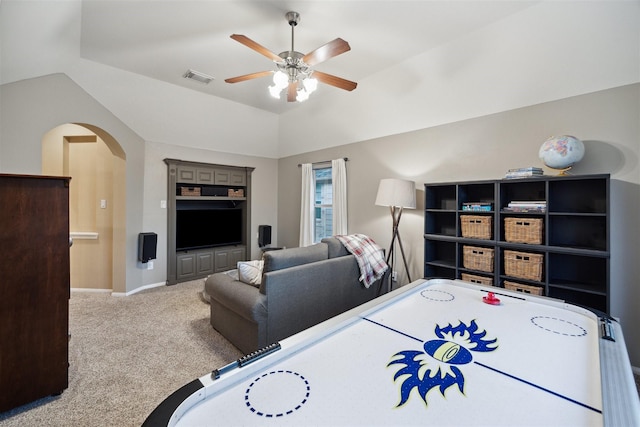 bedroom with vaulted ceiling, ceiling fan, and light carpet