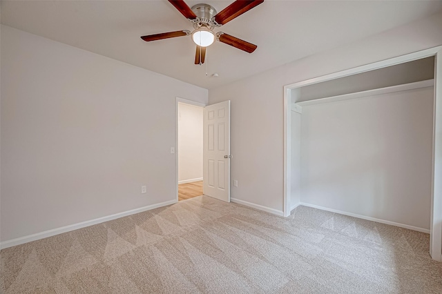 unfurnished bedroom featuring a closet, ceiling fan, and light colored carpet