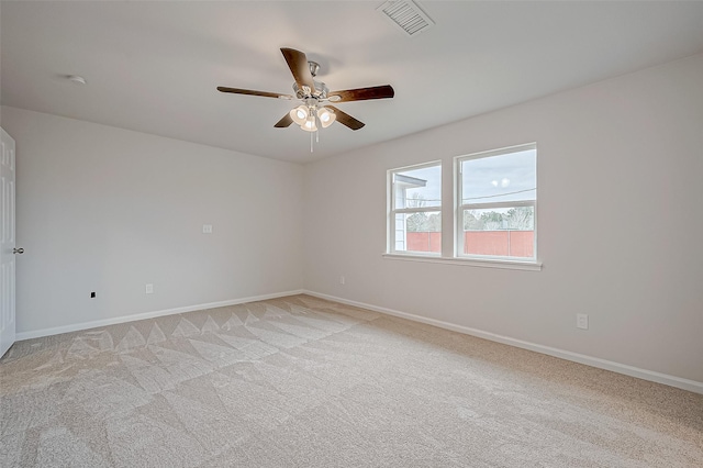 unfurnished room with ceiling fan and light carpet