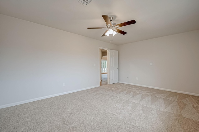 carpeted spare room featuring ceiling fan