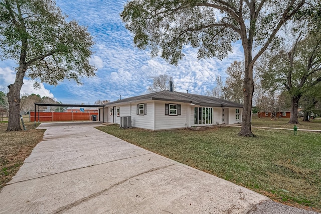 single story home featuring a carport, a front yard, and central AC unit