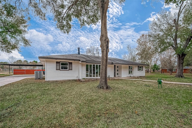 single story home featuring central AC unit and a front lawn