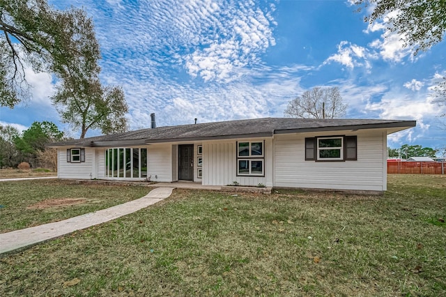 ranch-style home featuring a front yard