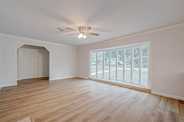 interior space with ornamental molding, ceiling fan, and light hardwood / wood-style flooring