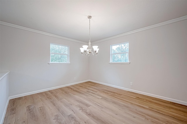 unfurnished room featuring a healthy amount of sunlight, light hardwood / wood-style floors, and ornamental molding