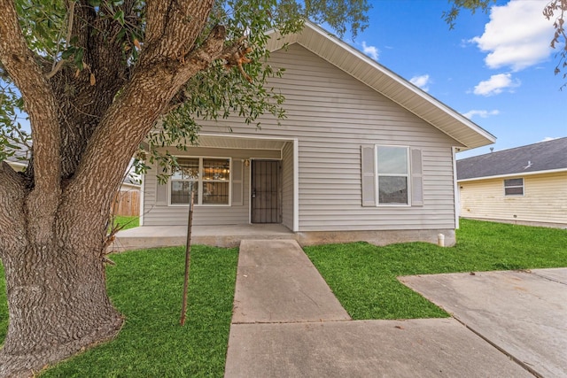 bungalow-style house featuring a porch and a front lawn