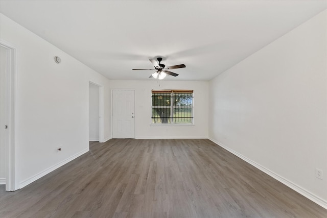 spare room featuring dark hardwood / wood-style flooring and ceiling fan