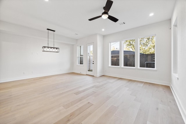 unfurnished living room with light wood-type flooring and ceiling fan