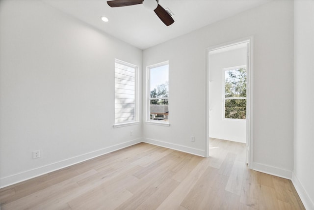 empty room with light wood-type flooring, ceiling fan, and a healthy amount of sunlight