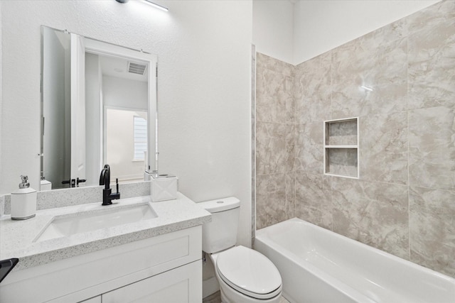 full bathroom with tiled shower / bath combo, vanity, and toilet