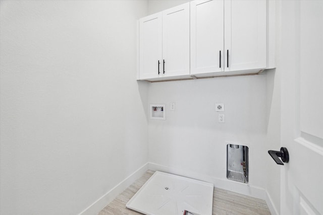 clothes washing area with washer hookup, cabinets, and electric dryer hookup