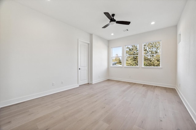 empty room featuring light wood-type flooring and ceiling fan