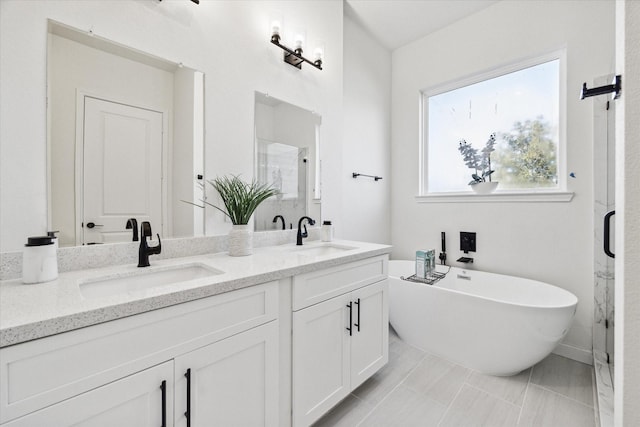 bathroom featuring shower with separate bathtub, a healthy amount of sunlight, and vanity