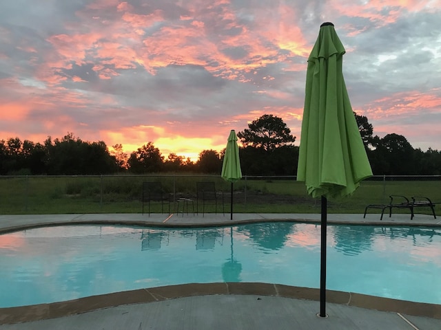 view of swimming pool featuring fence and a fenced in pool