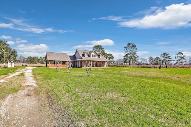 view of yard featuring a rural view and dirt driveway