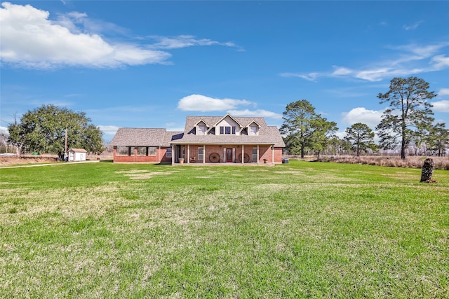 view of front of property featuring a front yard and brick siding