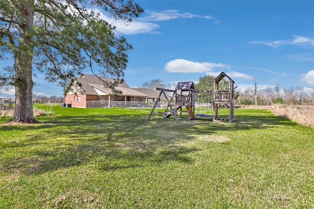 view of yard featuring a playground and fence