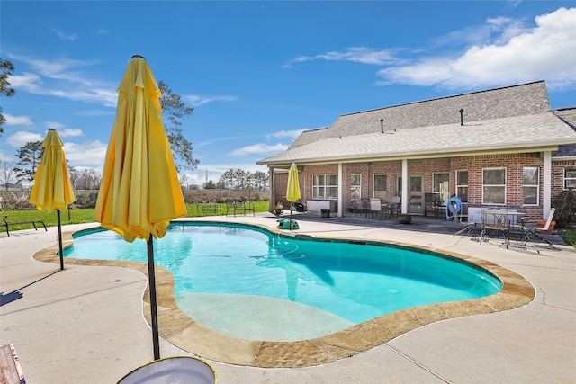 pool with a patio and fence