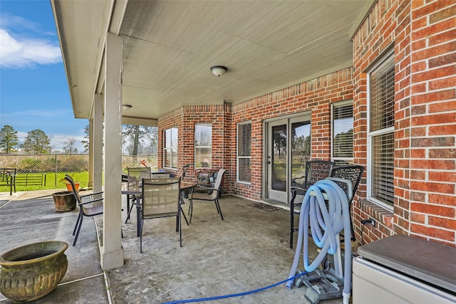 view of patio / terrace with outdoor dining area and fence