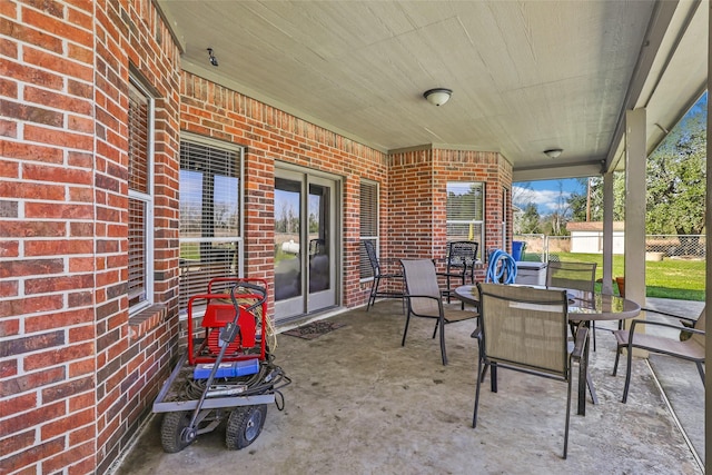 view of patio featuring outdoor dining area and fence