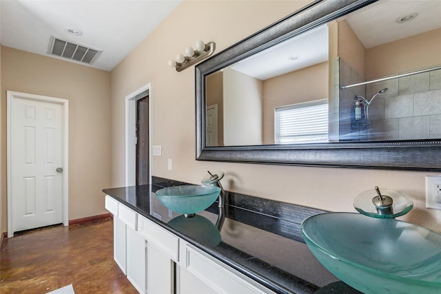 full bath with double vanity, baseboards, visible vents, concrete floors, and a sink