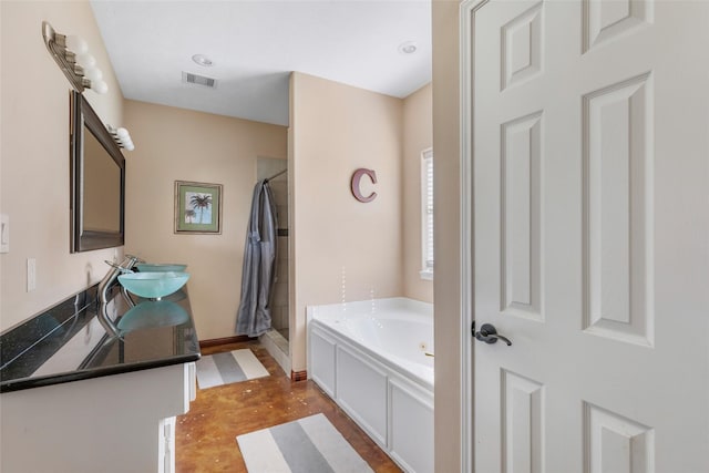 full bathroom with concrete flooring, a garden tub, visible vents, double vanity, and a stall shower